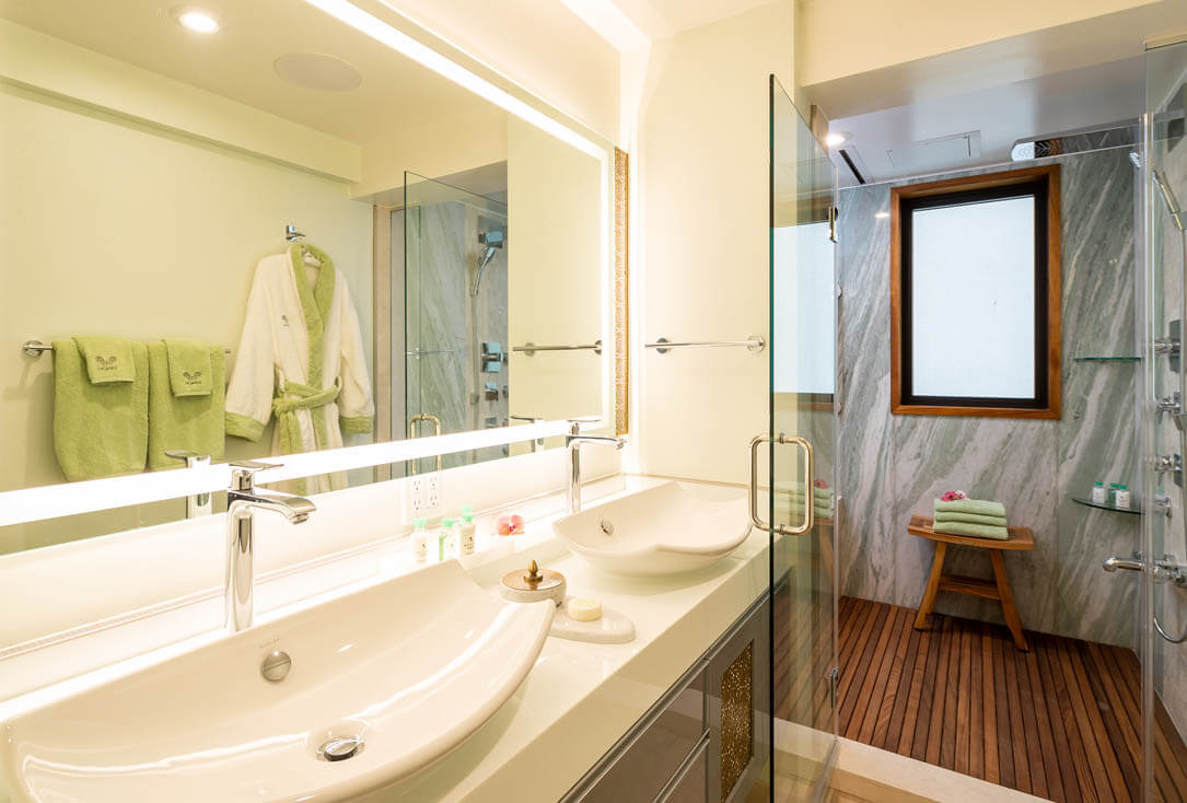 Bathroom with 2 sinks, large mirror, and sauna.