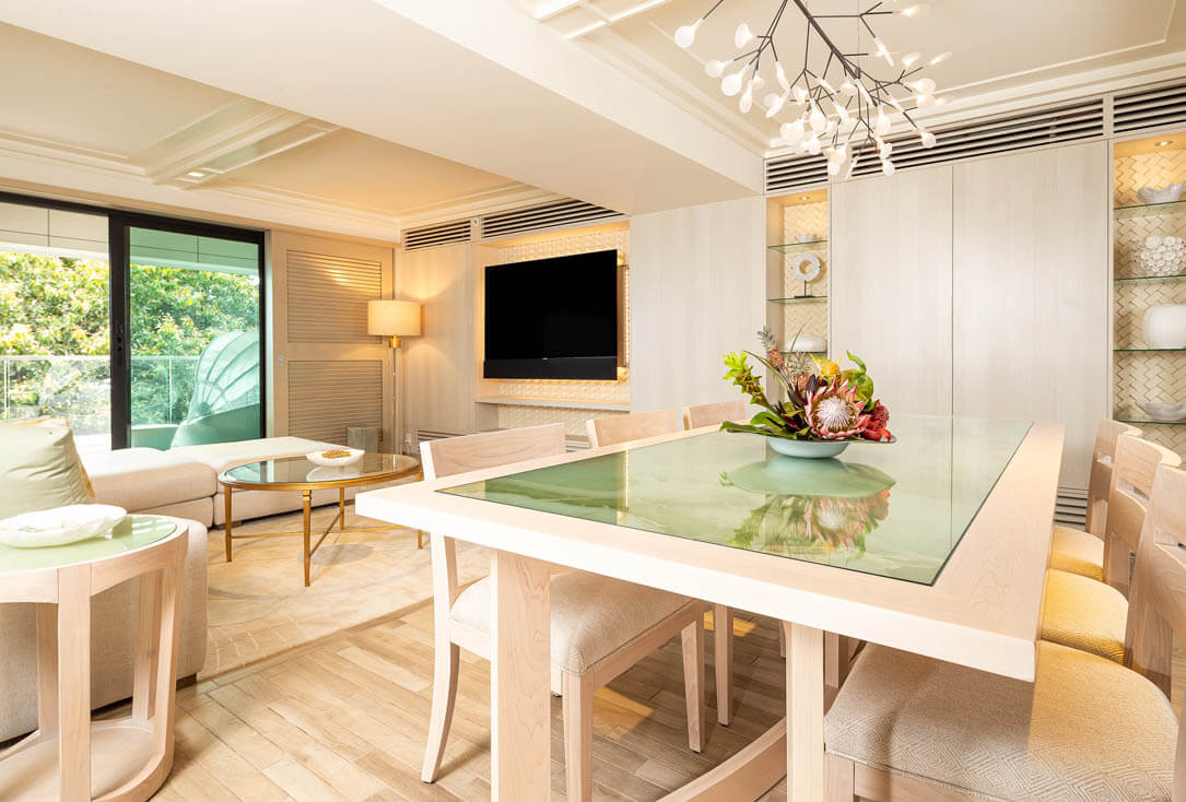 Living area with couch and TV, and dining table with chairs.